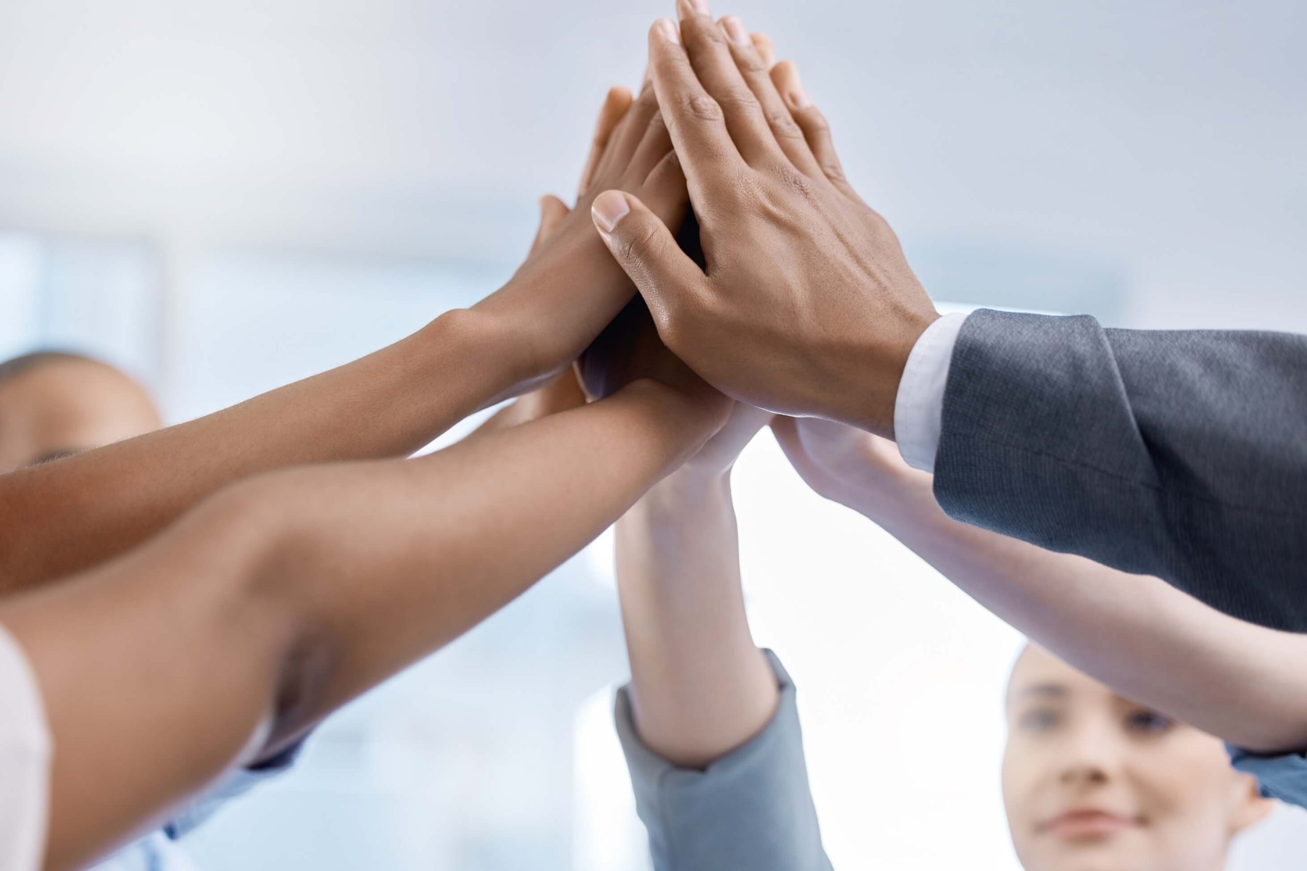 hands-of-corporate-team-in-diversity-partnership